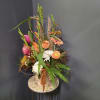 Tall mixed floral arrangement in a vase with orange, pink, and white blooms
