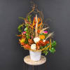 Tall floral arrangement with orange, pink, and white blooms in a white vase