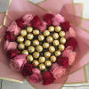 Heart-shaped bouquet of pink and red roses with gold-wrapped chocolates
