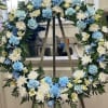 Blue and white floral wreath on a stand