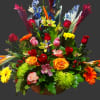 Colorful mixed flower basket with roses, orchids, and gerbera daisies