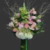 Pink and white floral arrangement in a tall green vase