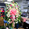 Large pink and white floral standing spray with a pink bow