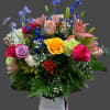 Mixed bouquet with roses, lilies, and blue delphinium in a box