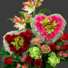 Heart-shaped bouquet of red and pink roses with white orchids and lilies