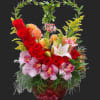 Basket arrangement of red roses, pink orchids, and lilies with a heart-shaped greenery handle