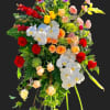 Tall standing floral spray with red, white, yellow, and peach blooms