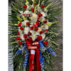 Standing floral spray with red and white flowers and blue accents