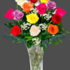 Colorful roses arranged in a clear glass vase