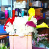 Flower gift box with white and red blooms and a box of chocolates