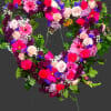 Heart-shaped floral wreath with pink, purple, and white flowers