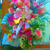 Large standing floral spray with pink and peach blooms on an easel