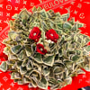 Bouquet of folded dollar bills with red roses on a red patterned background