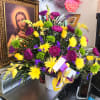 Bright mixed bouquet in a white vase with yellow and purple flowers