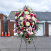Large standing floral spray with red and white flowers on an easel