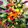 Large tropical floral spray with orange, pink, purple, and yellow blooms