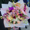 Pink and peach bouquet with orchids, roses, and calla lilies
