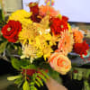 Bouquet of red roses, yellow chrysanthemums, and peach gerbera daisies
