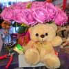 Pink rose bouquet with a teddy bear and ribbon