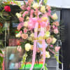 Large pink and cream floral standing spray with ribbon and name accents