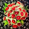 Bouquet of red roses wrapped in dollar bills with green leaves