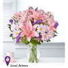 Pink lilies and daisies in a clear glass vase