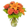 Orange roses and lilies in a clear glass vase