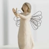 Wooden angel figurine holding a small candle