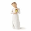 White figurine of a person holding a gold heart