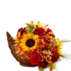 Autumn floral arrangement in a wicker cornucopia with sunflowers and red blooms