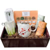 Tea gift basket with a floral teapot, mug, and assorted tea tins