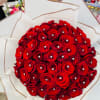 Large bouquet of red roses wrapped in white paper