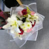 Bouquet of white lilies, red roses, pink carnations, and white daisies