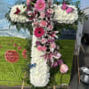 Large floral cross with pink and white flowers and butterfly accents