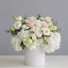 White and blush bouquet in a white cylindrical vase