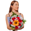 Woman holding a bouquet of red roses, a sunflower, and pale pink daisies