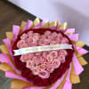 Heart-shaped bouquet of pink and red roses with a ribbon banner