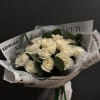 Bouquet of white roses wrapped in printed paper