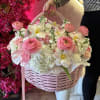 Pink and white flower basket with a ribbon handle