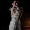 Bride in a white gown holding a lavender and white floral bouquet
