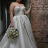 Bride in a white gown holding a white bouquet