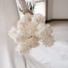 Bride holding a bouquet of white roses