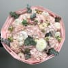 Bouquet of pale pink flowers with white blooms and eucalyptus in pink wrap