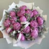 Pink peony bouquet wrapped in white paper with a ribbon