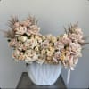 Large bouquet of pale pink and cream roses in a white vase