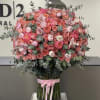 Large pink and coral rose bouquet with eucalyptus and a pink ribbon