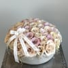 Round bouquet of blush and cream roses with a ribbon bow