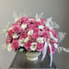 Pink and white rose bouquet in a white vase