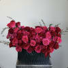 Large bouquet of pink and red roses in a dark vase