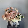 Blush roses and white anemones in a metal vase